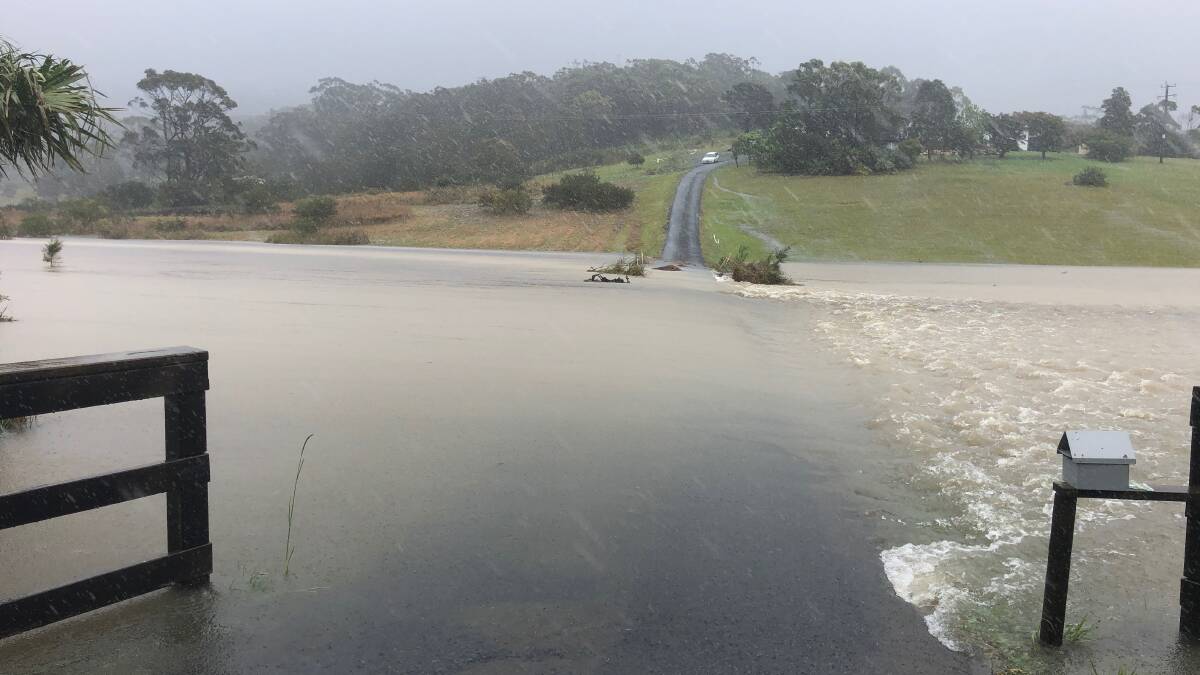 A driveway off Coomba Road is left completely underwater by the torrential rain. Photo: Nick Montague.