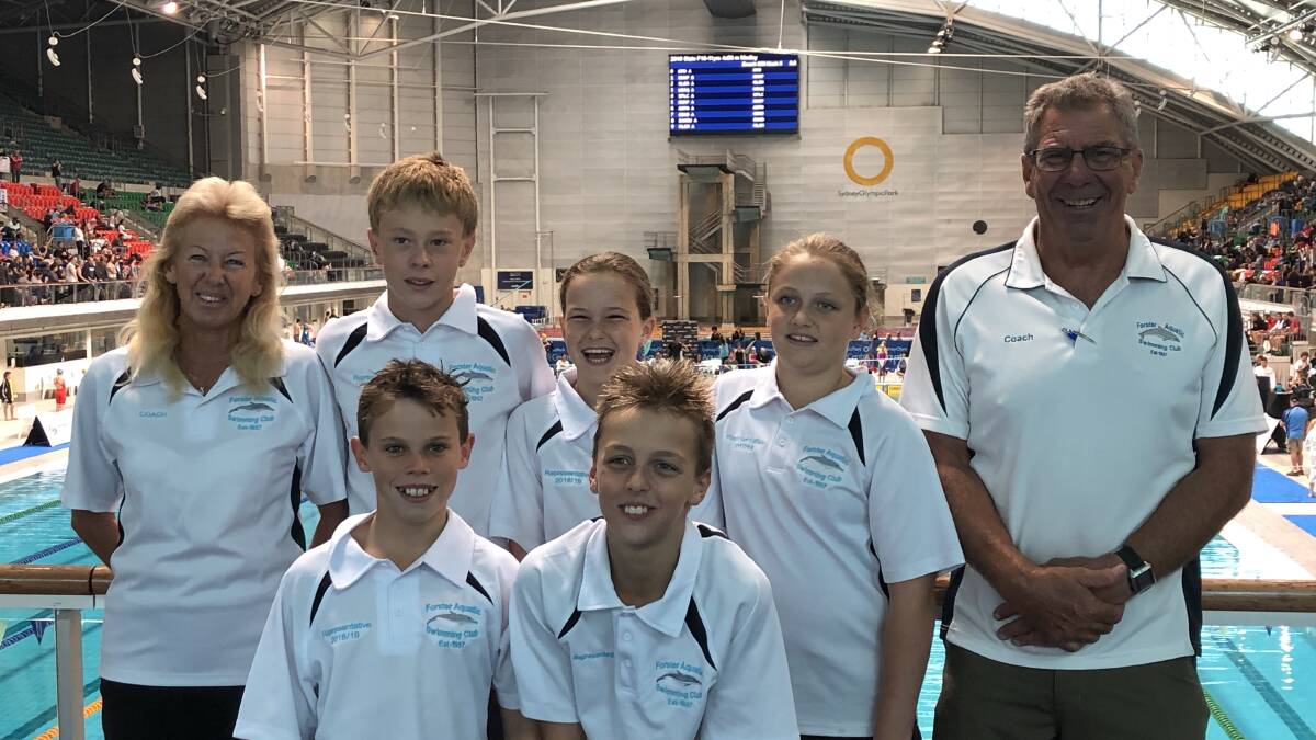 Forster swimmers at the Swimming NSW Junior State Championships, with coaches Adel Gregory and Peter Sanders.