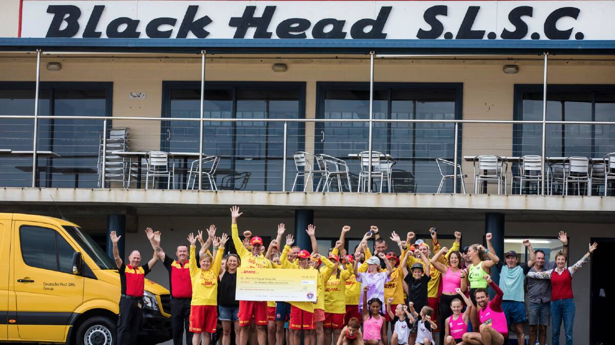Members of Black Head SLSC celebrate the $5000 Jayme won for the club.