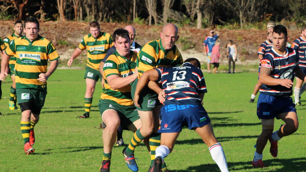 Dolphins' veteran Tom Harris is tackled by Wauchope centre Jason Sibarani with hooker Nathan Johnson in support. (Photo: Sue Hobbs)