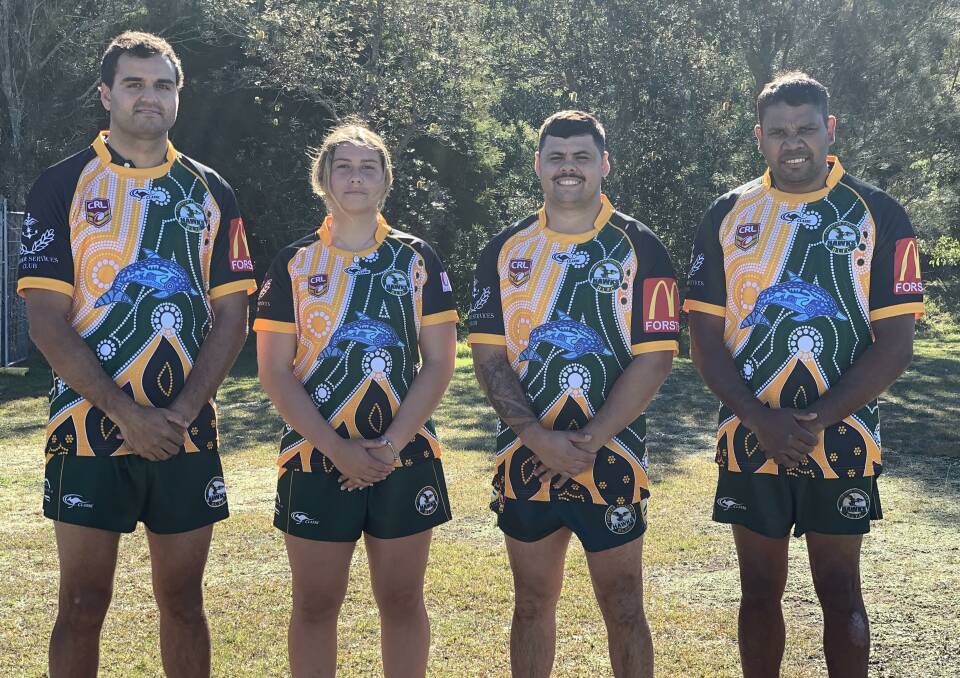 Forster Tuncurry Hawks' players show off their strip for this weekend's Indigenous round.