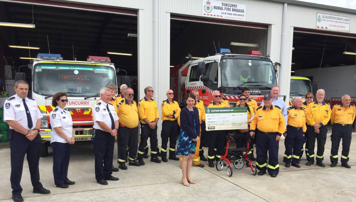 Premier Gladys Berejiklian and member for Myall Lakes Stephen Bromhead with members of the Tuncurry RFS.