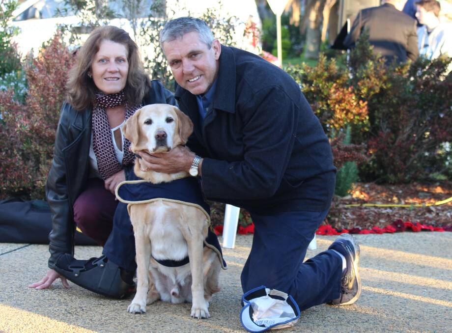 Mark Jensen and partner Jane with a retired air force explosives detection dog at the Tuncurry ANZAC dawn service.