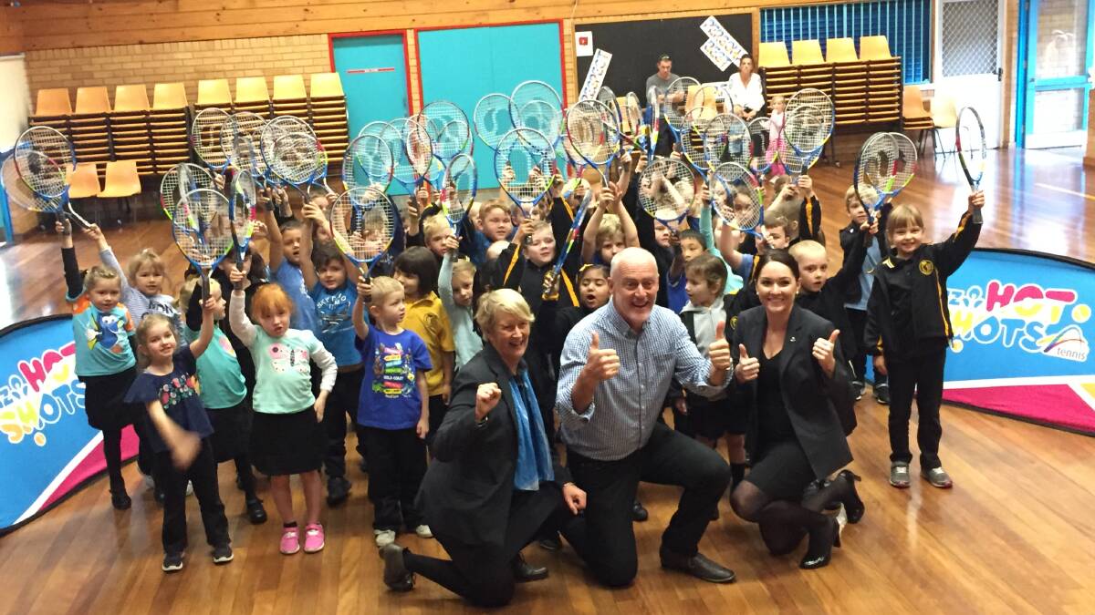 John Fitzgerald and ANZ representatives gifted students with new tennis racquets.