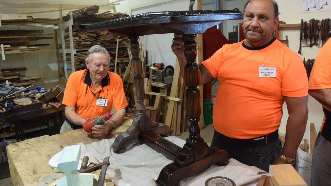 Shed members, Brian Booth and Alexander Apostoldis restoring a 100 year old table.