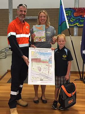 Essential Energy’s Head of Stakeholder Engagement Roger Marshall congratulates Bronte Kippax and teacher Jessica McConnachie at the Hallidays Point Public School end of year presentation.