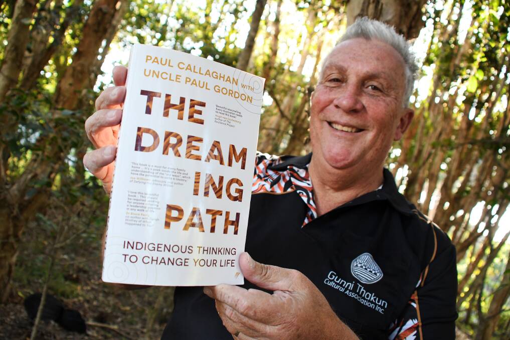 Paul Callaghan at Saltwater Reserve, with a copy of his best-selling book, The Dreaming Path. Picture by Scott Calvin