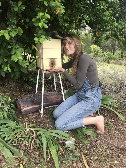 Chelsea Handswith one of her native sugar bag beehives, called an 'oath hive'. 