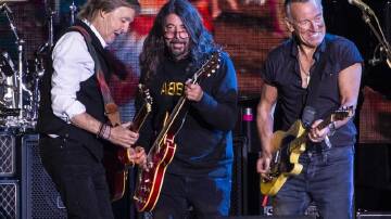 Dave Grohl and Bruce Springsteen came back for a final encore with Paul McCartney (L).