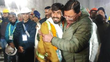 State chief minister Pushkar Singh Dhami has greeted construction workers rescued after 17 days. (AP PHOTO)