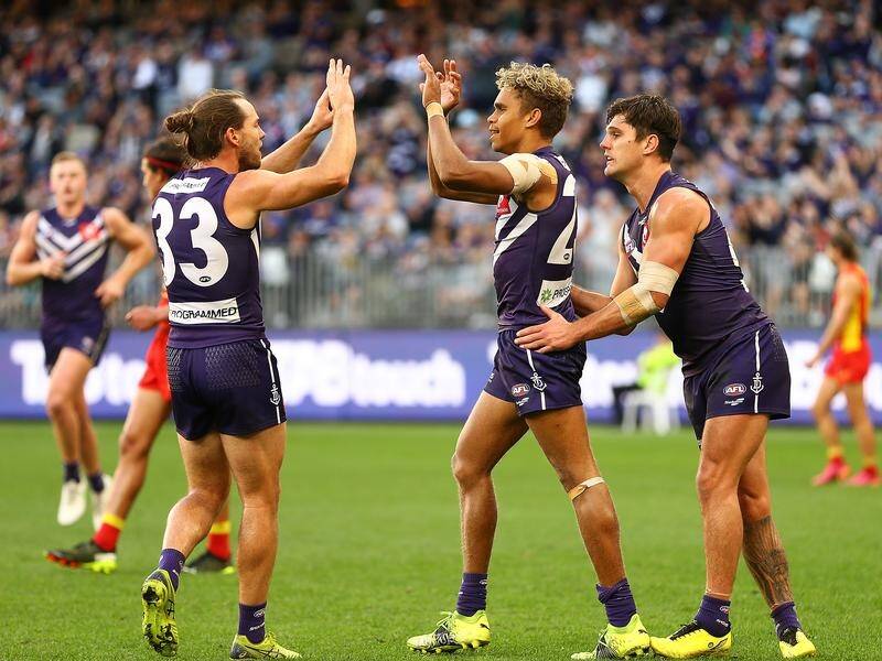 Fremantle's Liam Henry (c) celebrates kicking a goal during their AFL win over Gold Coast.