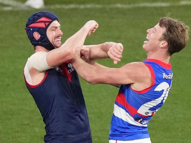Mitch Hannan of the Bulldogs gets in the face of Angus Brayshaw after scoring against the Demons.