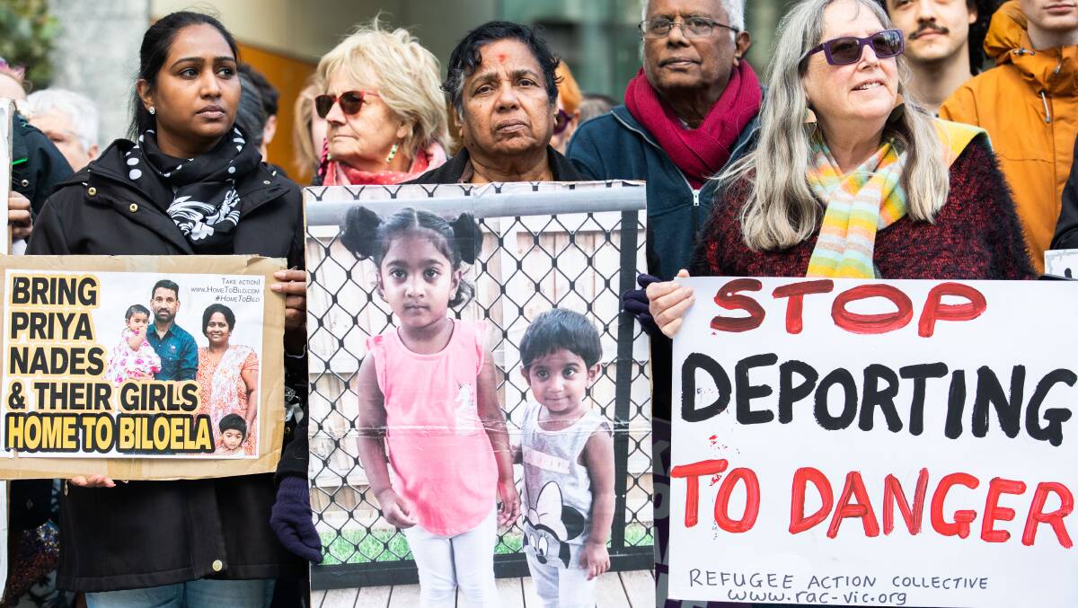 Supporters of the Murugappan family hold placards in support of their efforts to stay in Australia. The Tamil family were removed from their home in Biloela, central Queensland, in march 2018, and taken to immigration detention. Picture: Getty Images