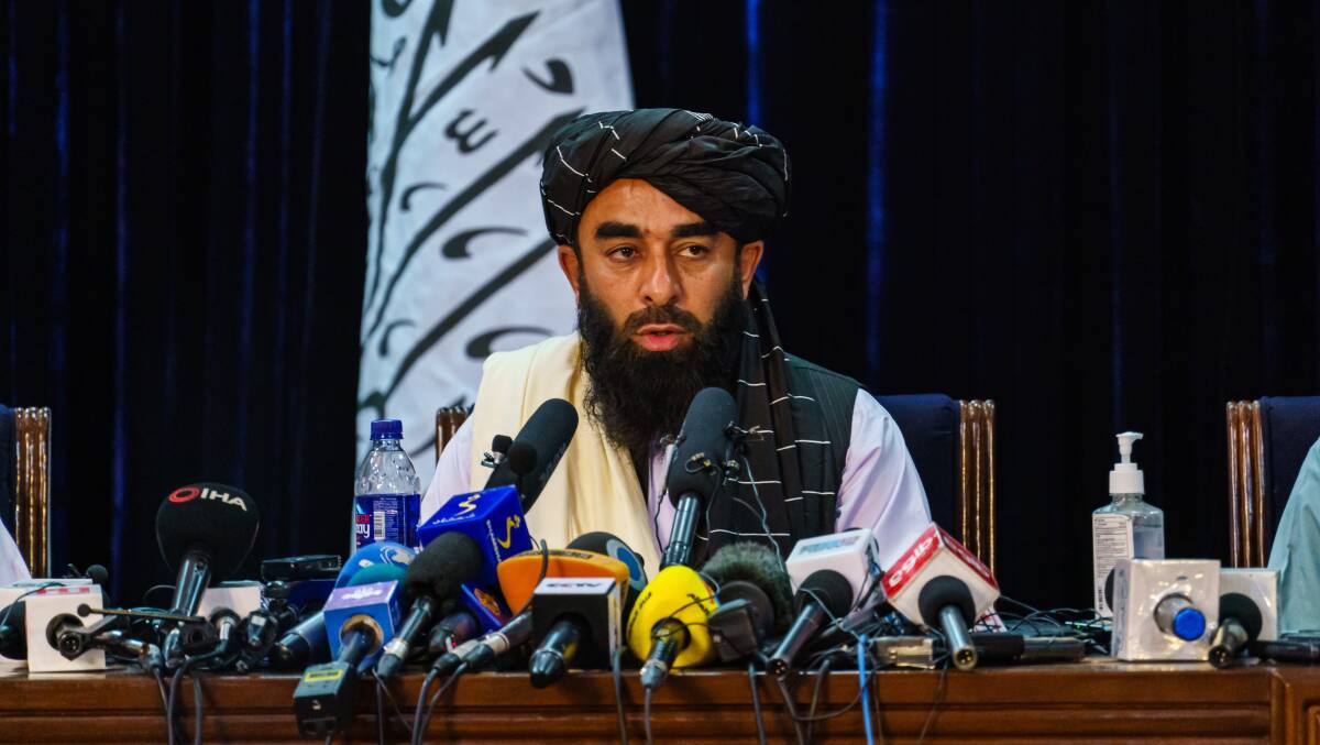 Taliban spokesman Zabihullah Mujahid holds a press conference in Kabul's presidential palace on Tuesday. Picture: Getty Images
