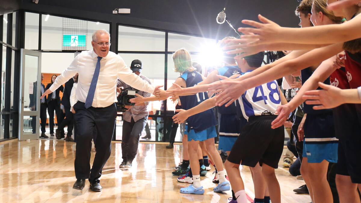 Prime Minister Scott Morrison high-fives under-12 basketballers in Corangamite. Picture: James Croucher