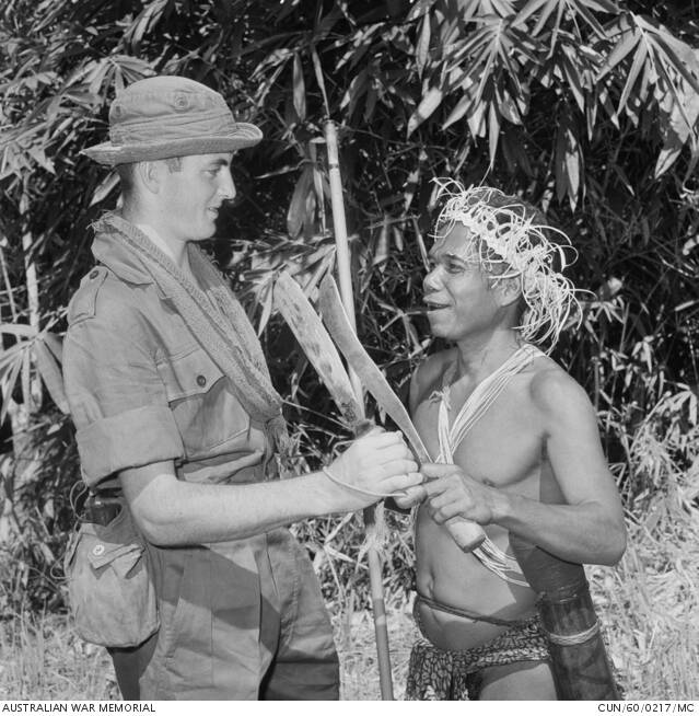 Twenty-one-year-old Private John W Gillan, Leeton,1st Battalion, The Royal Australian Regiment (1RAR) and local tribesman, Itam Bosu comparing an army issue jungle knife and a traditional Malay parang. Itam Bosu was returning to his kampong (village) after visiting the local market place near the 1RAR company lines. Photo courtesy the Australian War Memorial. 