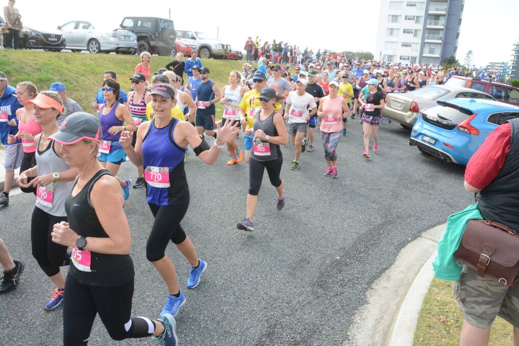 Determination: Competitors run through the streets of Forster in the 10 kilometre event. Photo: Scott Calvin. 