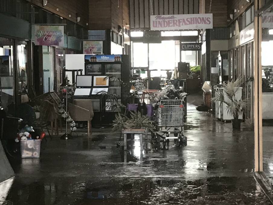 Clean-up begins: Shops in Pulteney Arcade were damaged by flood water on the weekend.