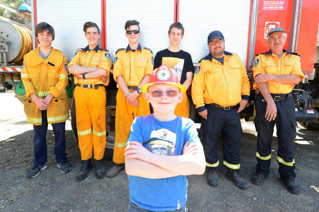 Budding firefighter Jacob Ellison with members of the Lansdowne RFS at the 2019 Get Ready Weekend. Photo: Scott Calvin.