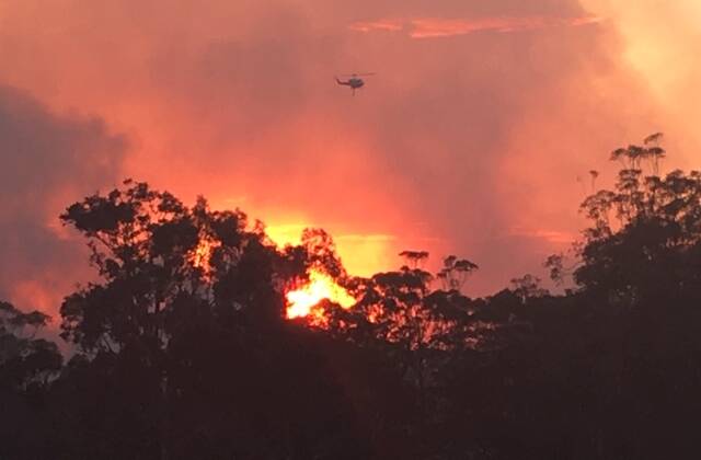 A helicopter flies overhead at Tallwoods Village. Photo: supplied.
