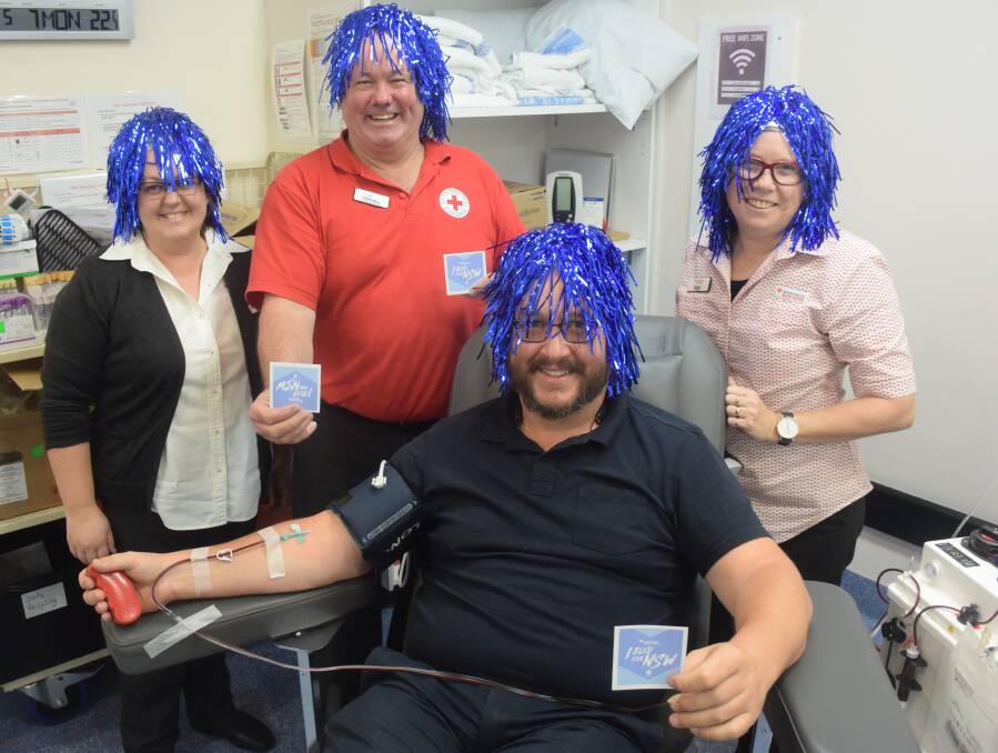 Decked out in blue: Nurse Brook Hudson, community relations officer Stuart Ward, donor Phil Davies and nurse Ange Callaghan show their support for the Blues at the Taree Blood Centre. Photo: Rob Douglas. 