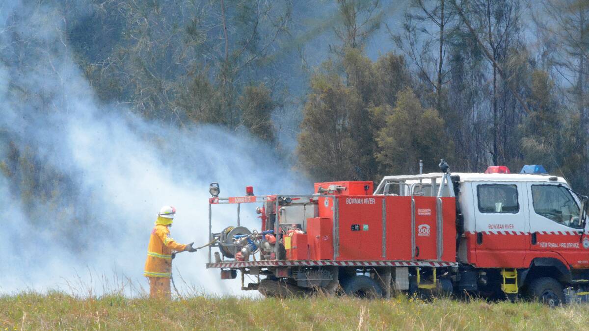 Fire crews attend to a bushfire at Darawank last year. 