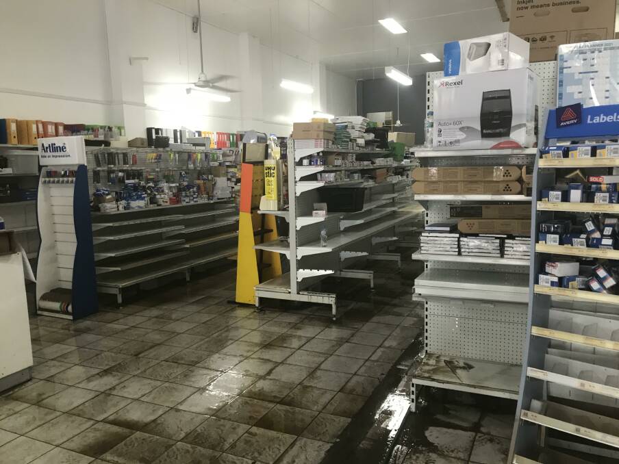 Water was swept out of the Holiday Coast Office Taree store on Monday.