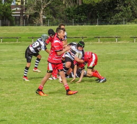 Brody Coble (black headgear) drives the ball up in the NSW Waratah Sevens Schools rugby union tournament at Tuncurry earlier this year.
