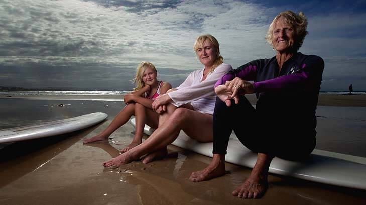 Sands of time: Abbey Mae (left), her mother Alison and grandmother Elaine Reid surf together at Byron Bay. "We were in the water before we could walk," Alison says. Photo: Danielle Smith
