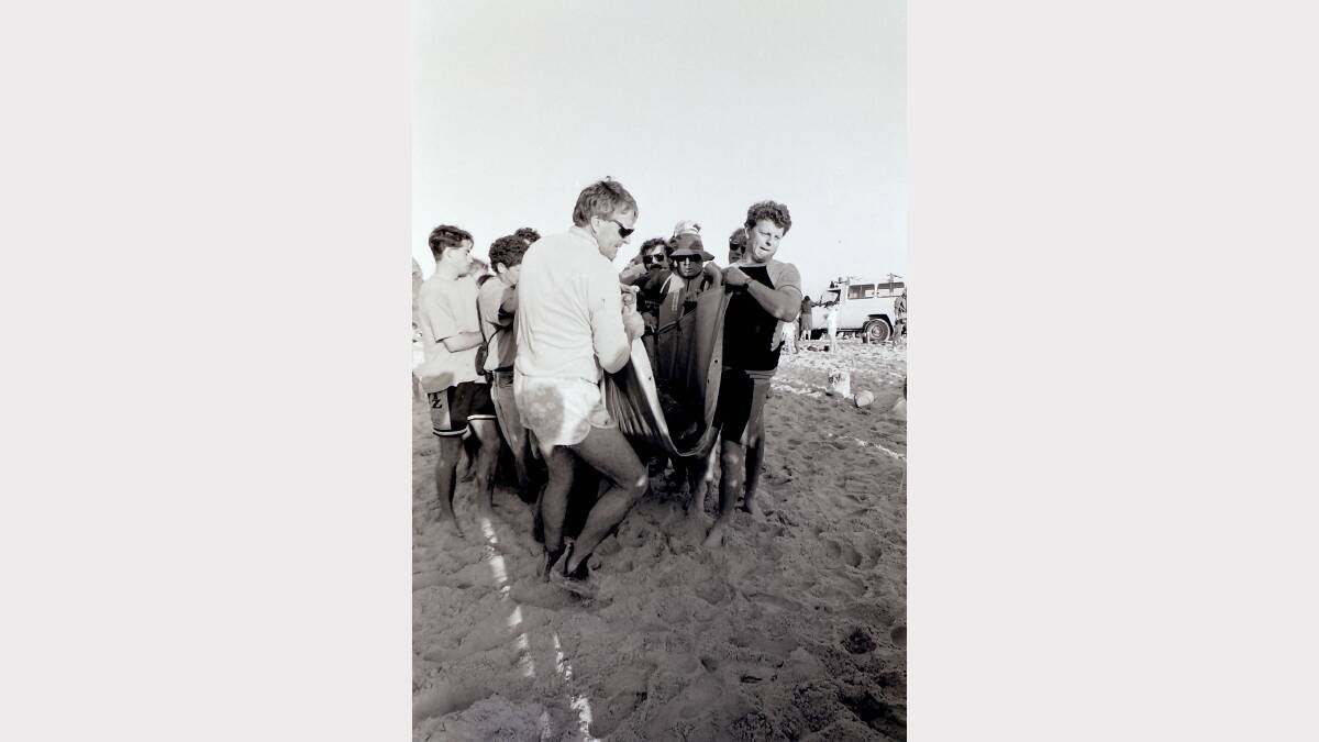 1992 WHALE RESCUE: These people were among almost 200 volunteers who worked through the night on Monday, July 13 1992 to help move a pod of stranded false killer whales. Volunteers managed to save 44 whales out of a pod of 49. Five died on the beach. 