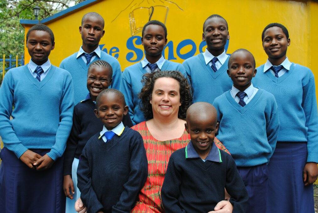 EDUCATION IS A WEAPON AGAINST POVERTY: Gemma Sisia with children from St Jude's school in Tanzania, East Africa. Gemma will talk about her charitable work on Friday March 15 at Club Forster.