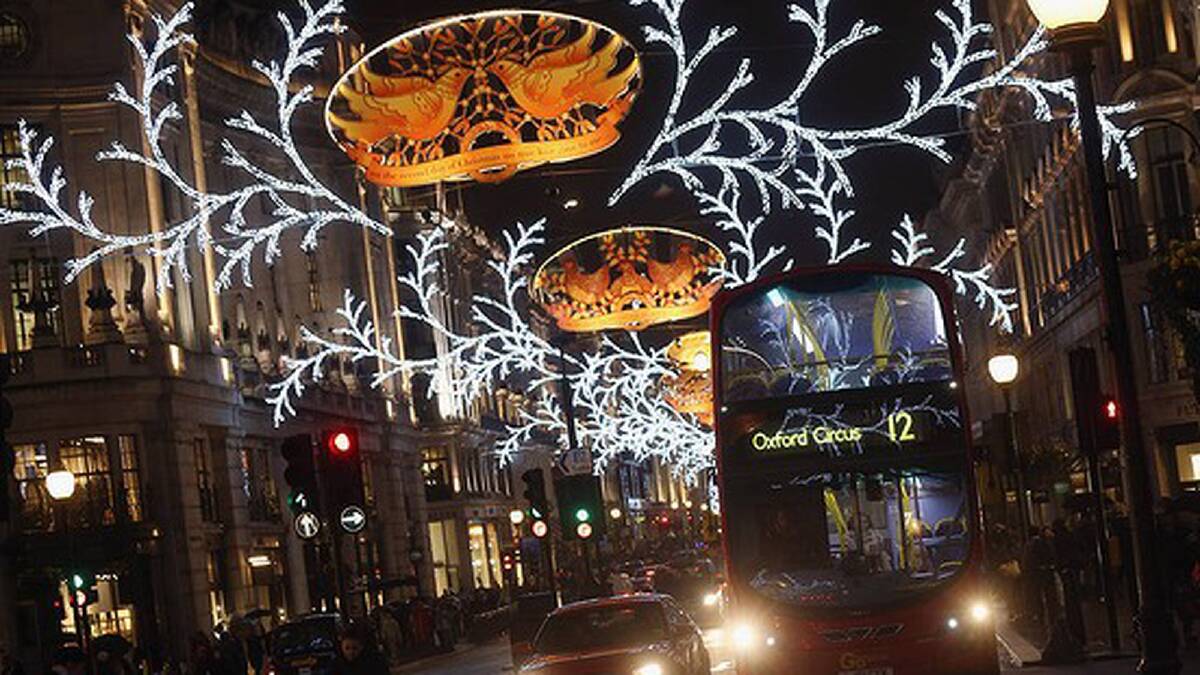 Traffic makes its way along a busy New Bond Street beneath the Christmas lights in London, England. Photo: Getty