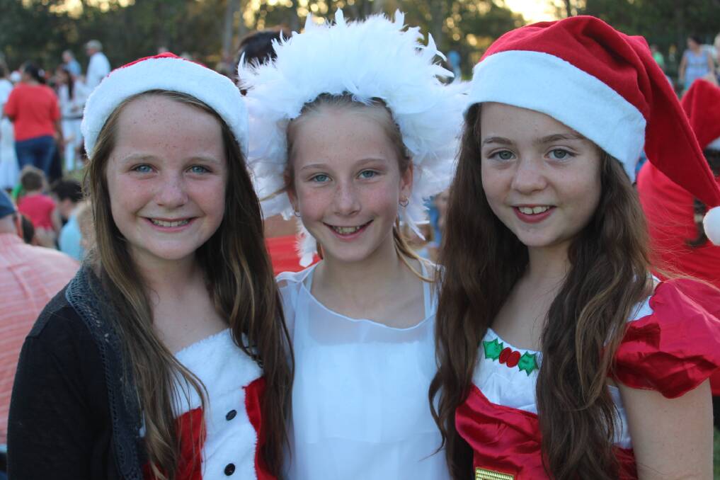 Best friends: Eva Fritsch, Emily Rourke and Steffani Adams get into the spirit of Christmas at their school’s end of year carols night. Photo:Port News