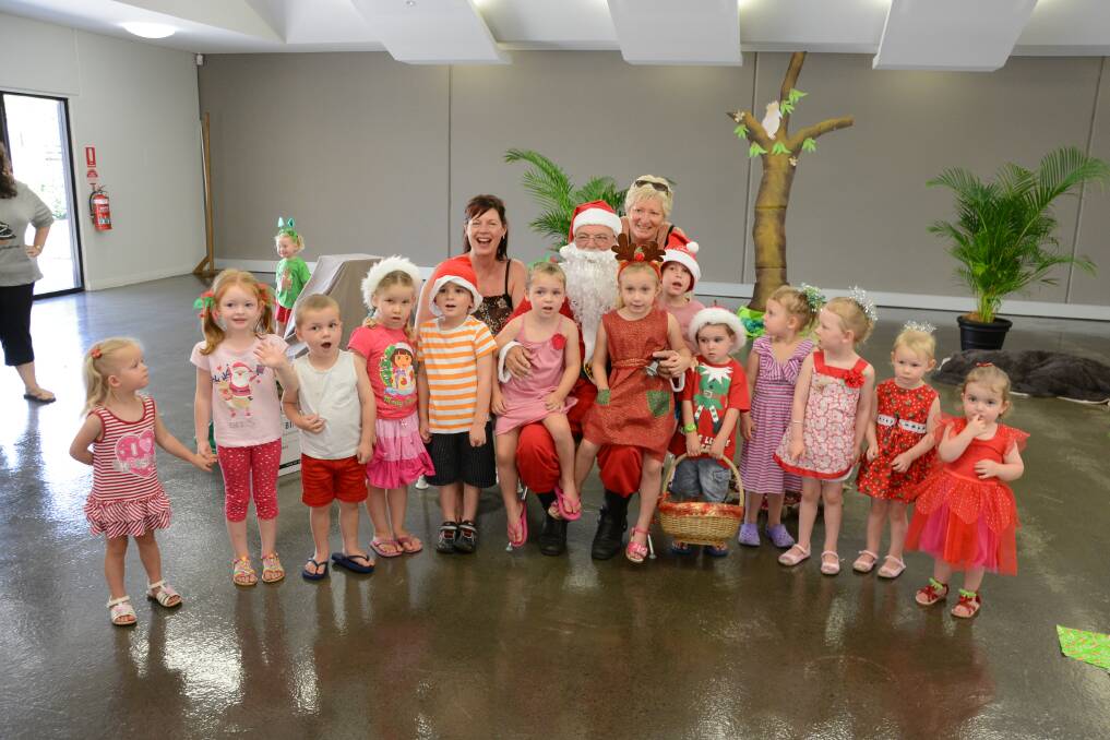  Festive fun: Santa is flanked by Harrington branch librarian, Di Pasfield and library assistant, Caroline Pattison and lots of happy preschool children (not in order) Lily Wells, Mia Wells, Cooper Mason, Lara Wallis, Quinn Ryan, Maddison Mason, Tia Benson, Mikayla Schroder, Olivia Plant, Alice Plant, Piper Gornell, Hannah Gornell, Kate Moore and Nate Hardy. Photo:The Manning River Times. 